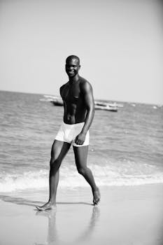 Man in white shorts enjoying a sunny day at the beach.