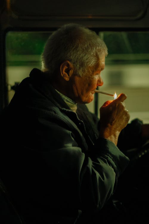 Free Elderly Man Lighting a Cigarette Stock Photo
