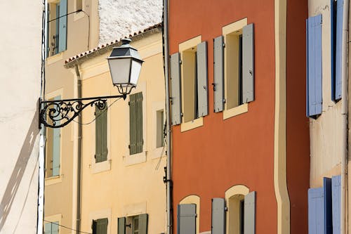 Hanging Street Lamp against Narrow Townhouses