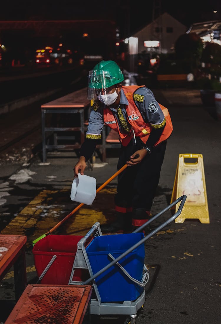 Street Cleaner With Cleaning Equipment At Railway Station