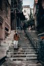 Man in Face Mask Going Down Stairs in Old District of Town