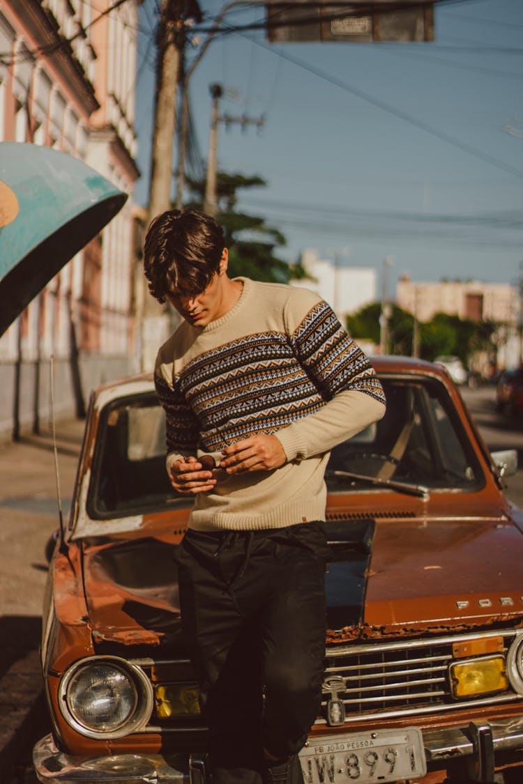 Young Man With Short Wavy Hair Standing Before Old Vintage Car