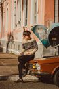 Male Driver Sitting on Old Car Mask and Waiting in Street