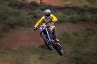 Man in Yellow and Black Motorcycle Suit Riding Motocross Dirt Bike