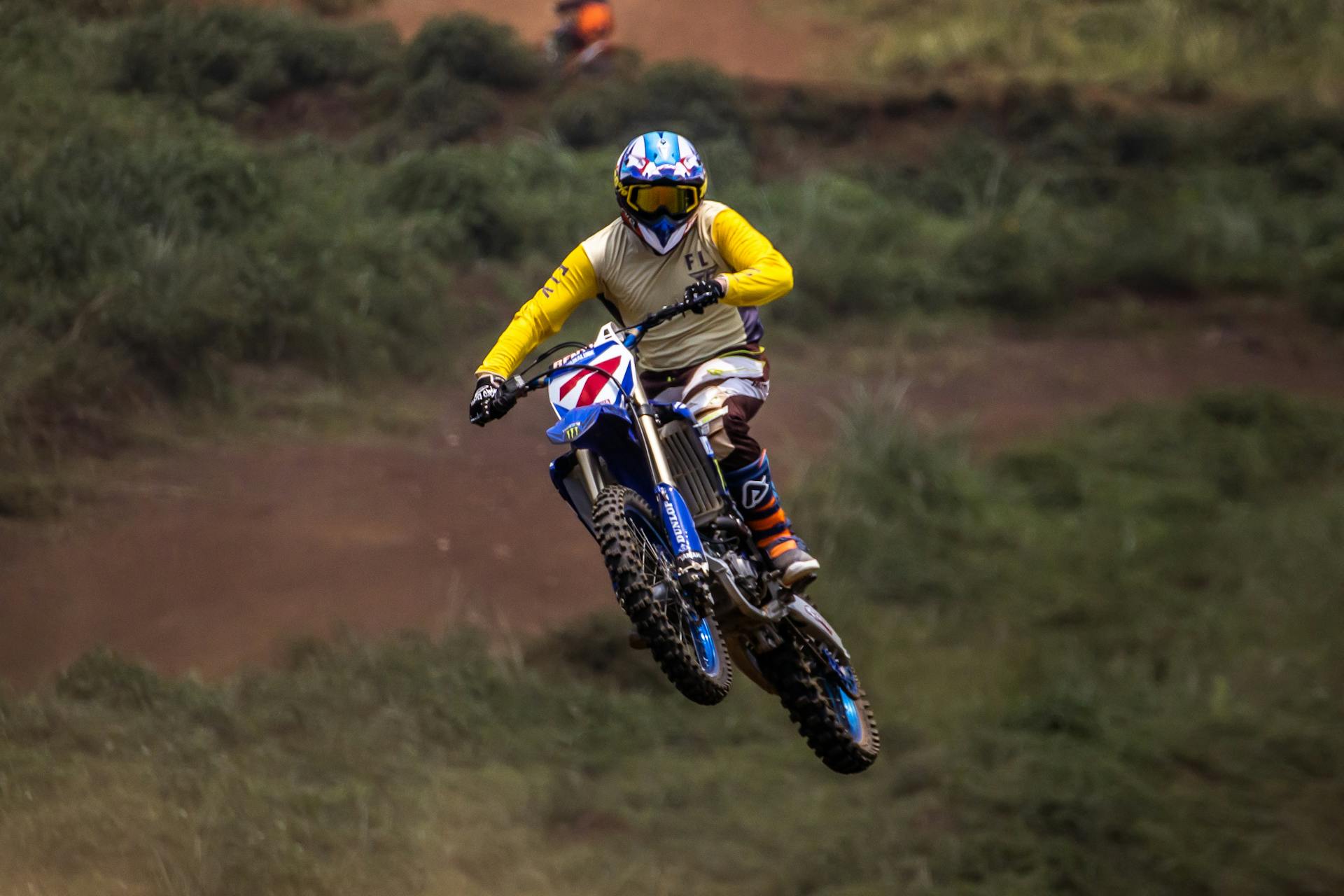 A dirt bike rider airborne during a motocross event, showcasing thrilling action and expertise.