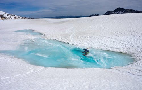 Person Riding on Snowboard during Daytime