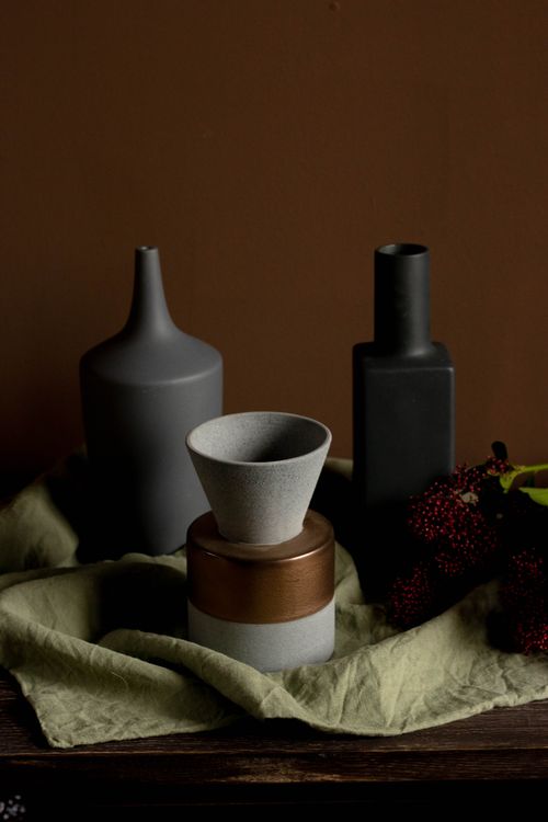 Free A still life of ceramic vases with fabric and flowers, ideal for home decor inspiration. Stock Photo
