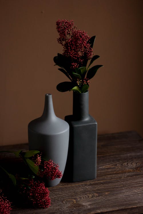 Flower in Vase Against Brown Wall