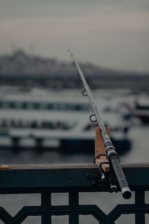 Free Close-up of a fishing rod on Galata Bridge with cityscape background, Istanbul. Stock Photo