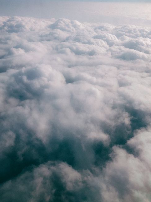Serene aerial shot of fluffy clouds from above, creating a peaceful skyscape.