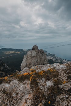 Scenic view of Ai-Petri mountain with a cloudy sky, showcasing nature's raw beauty and Crimea's iconic landscape.
