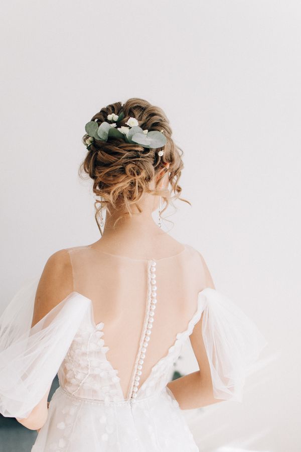 Elegant curly low chignon bridal updo