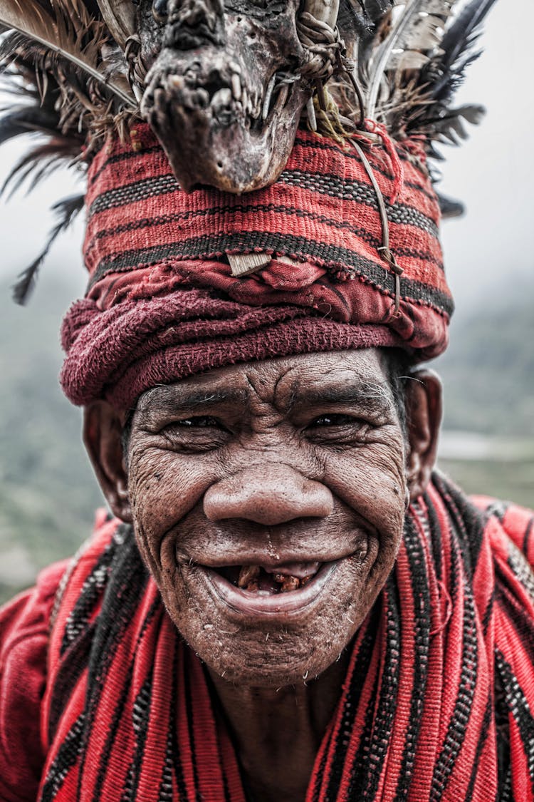 Portrait Of Elderly Man In Traditional Outfit Smiling At Camera