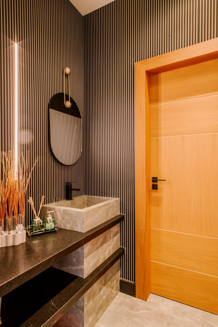 Bathroom With Door And Sink With Mirror