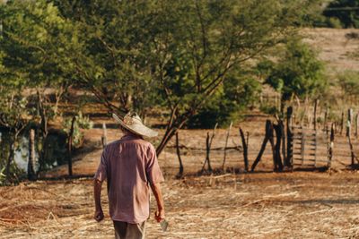 A farmer walking a parched field — photo by Jefferson Lucena on Pexels