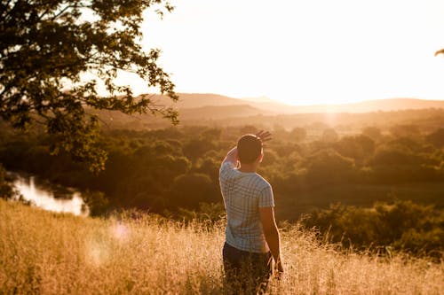 Man Standing on Grass Field