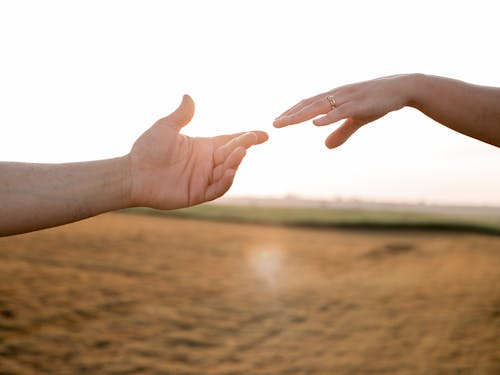 Free Hands Reaching Out to One Another Stock Photo