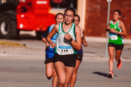 Free Dynamic shot of female athletes competing in an outdoor urban marathon race. Stock Photo