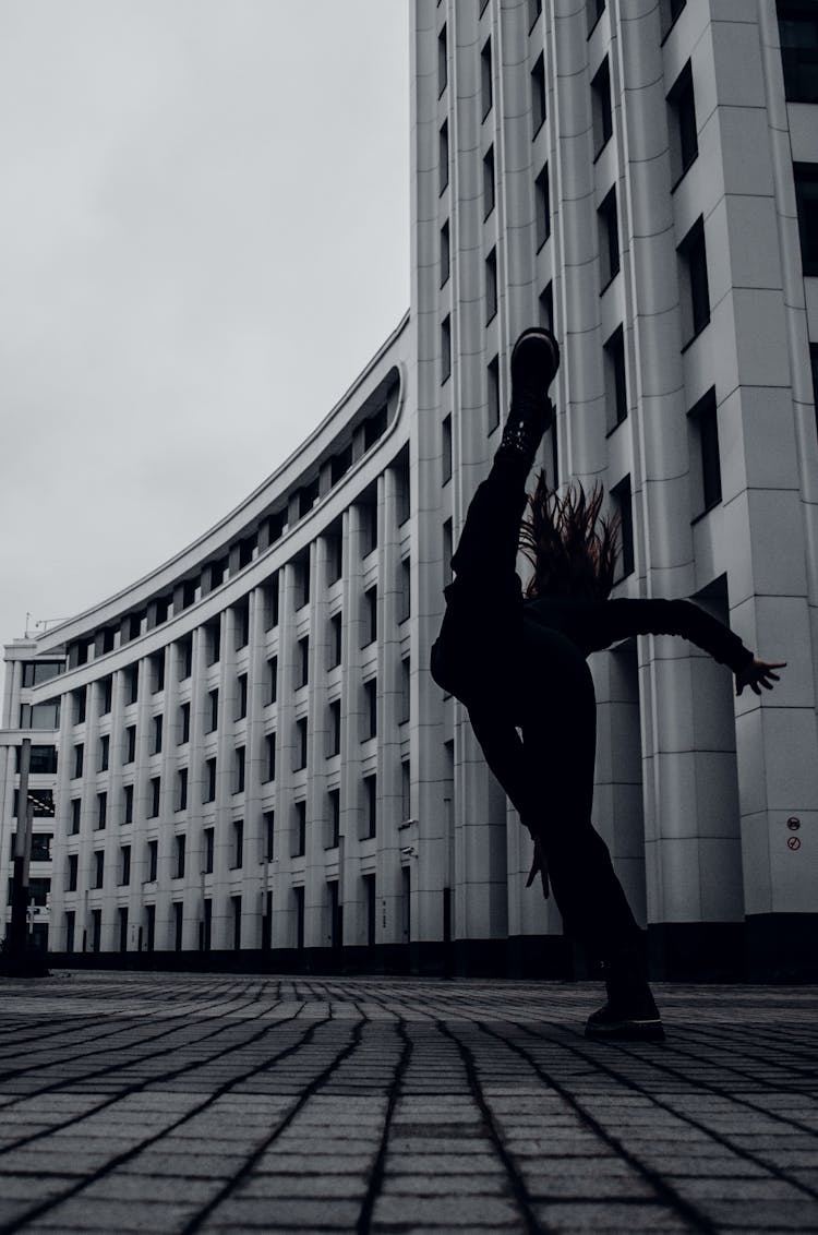 Woman Tripping In Front Of Building