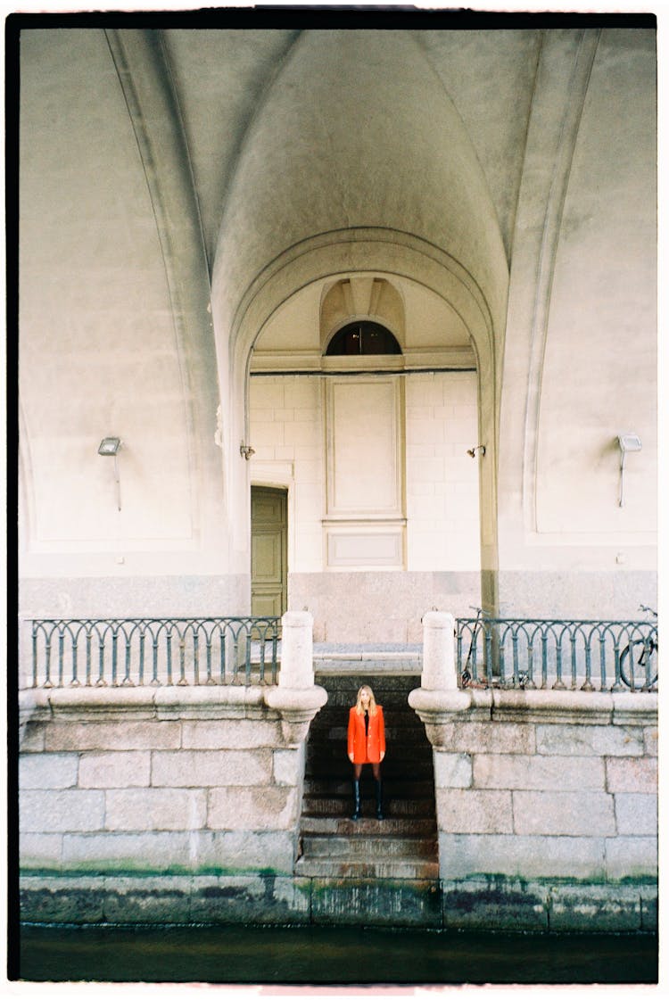 Woman Standing On The Steps By The Canal 