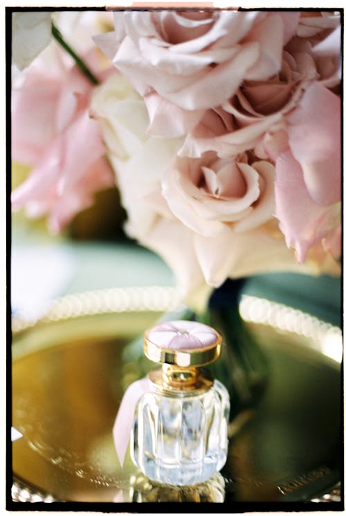 Phial of perfume and bunch of roses on the Tray 