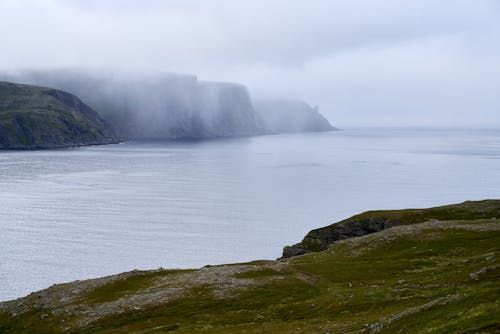 Cliffs Along Sea Behind a Fog 