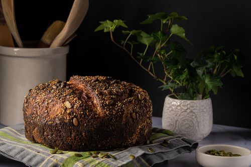 Free Close-up of artisan whole grain bread topped with seeds, ideal for culinary themes. Stock Photo