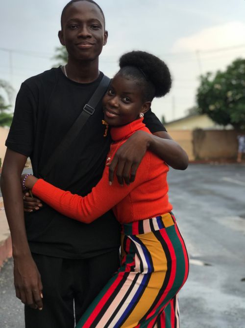 Free A cheerful couple embraces on a street in Ibadan, showcasing love and happiness. Stock Photo