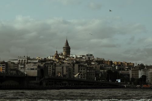 Free Scenic view of the iconic Galata Tower with cityscape and cloudy sky in Istanbul, Turkey. Stock Photo