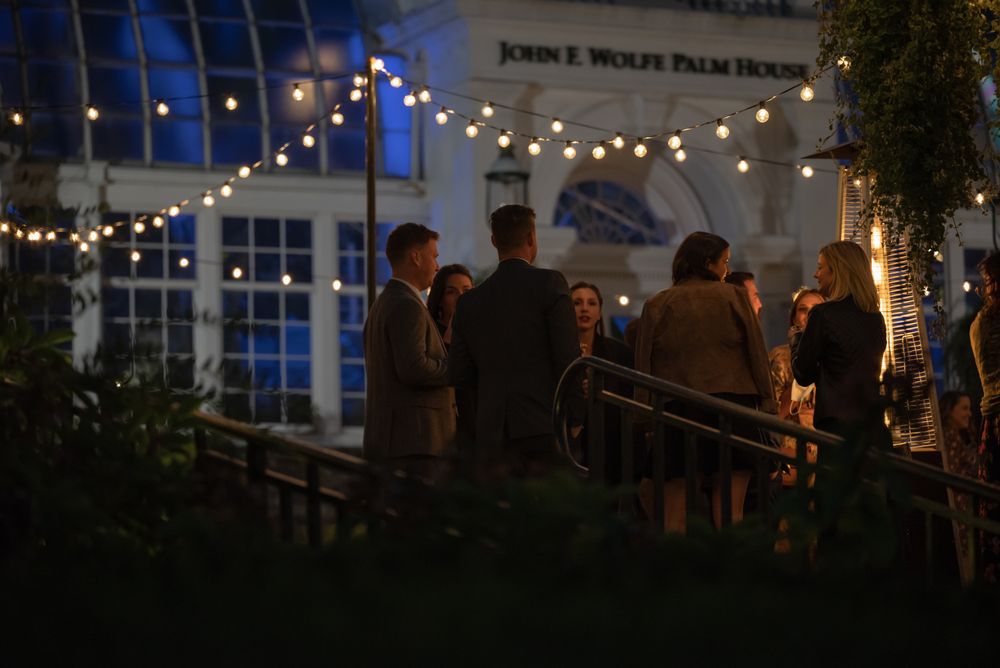 Evening patio gathering beneath warm string lights