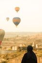 Man in Black Hoodie Standing Near Hot Air Balloons
