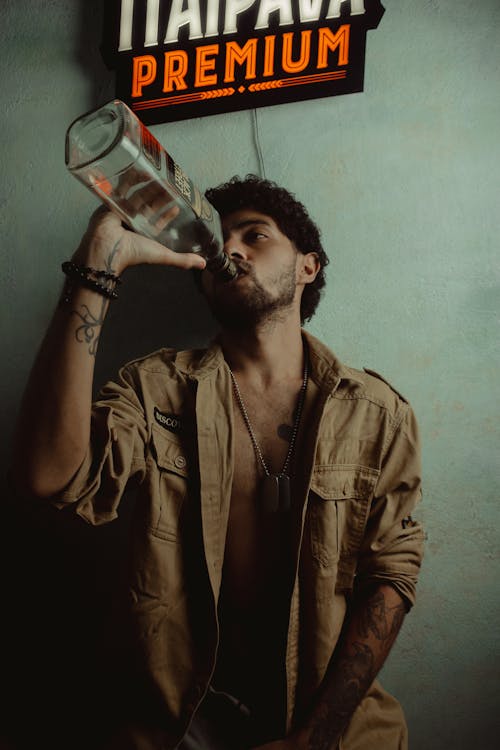 Free Man Drinking from an Empty Bottle Stock Photo