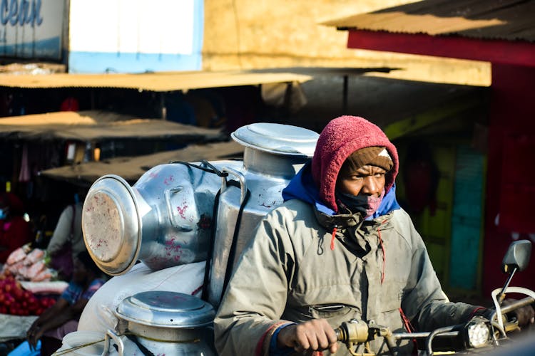 Man Transporting Containers On Motorcycle