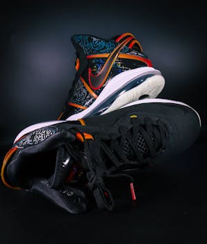Close-up of luxury sneakers with unique design and vibrant colors on a black background.