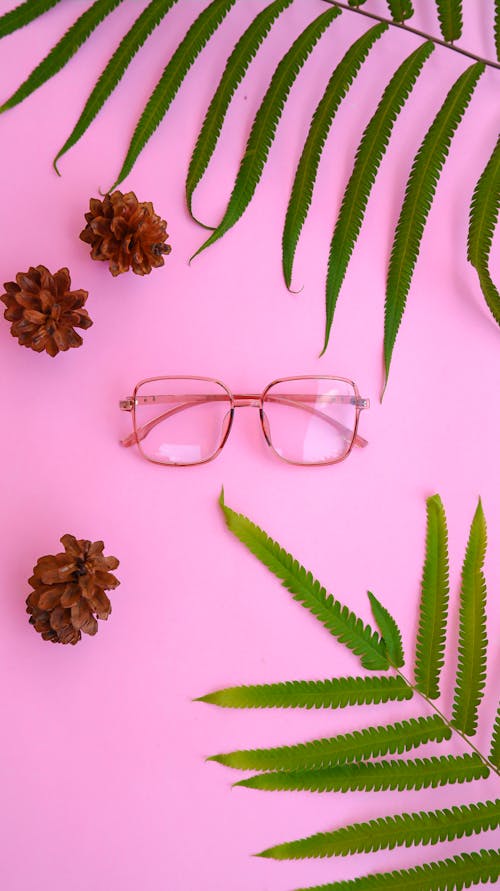 Flatlay Photography of Eyeglasses on Pink Surface