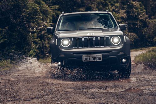 Free A rugged Jeep navigating a muddy off-road trail amidst lush greenery in São Paulo. Stock Photo