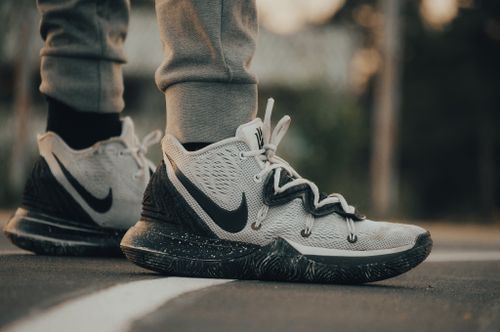 Free Stylish Nike sneakers on an asphalt road, perfect for sports and casual wear. Stock Photo