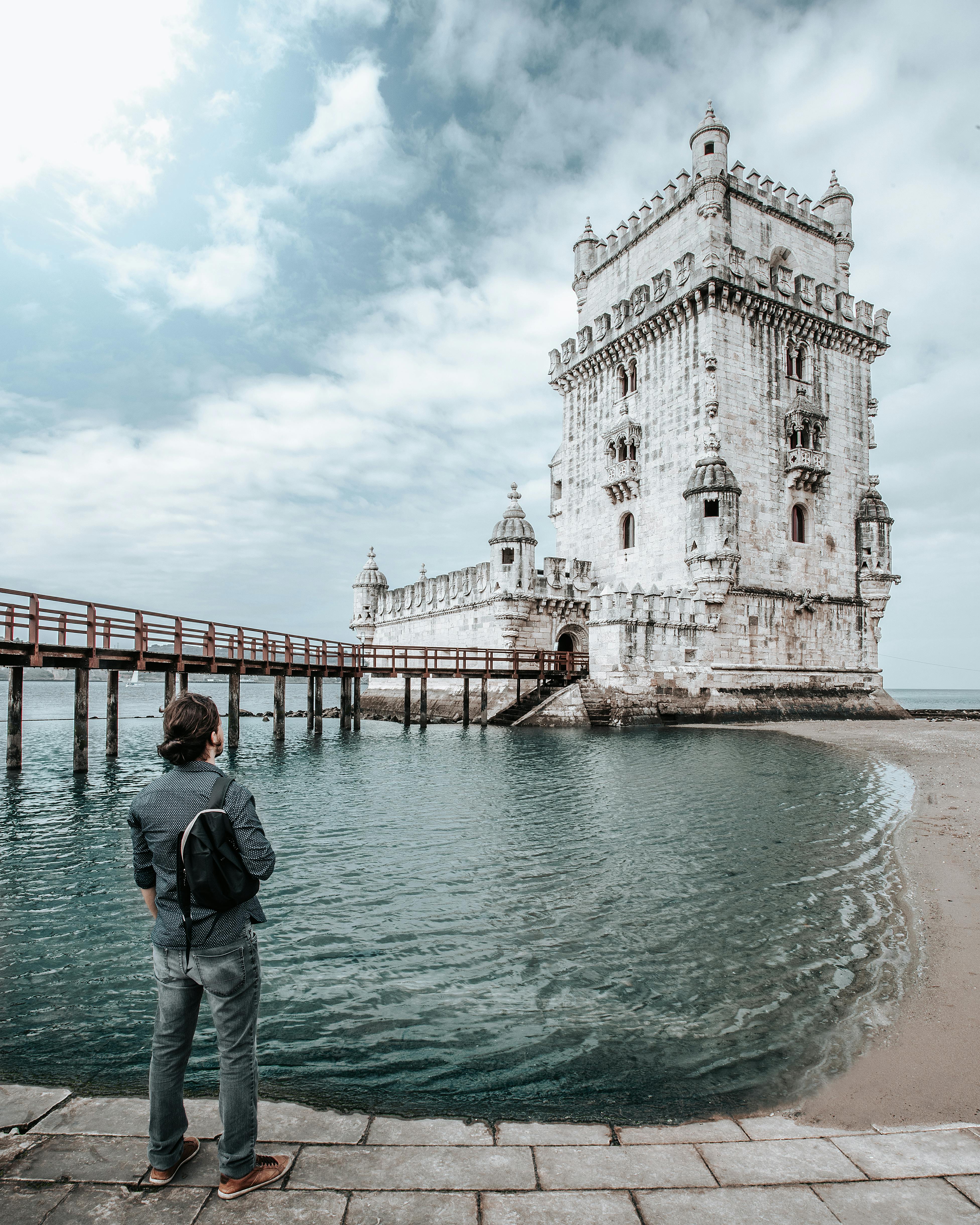 Free Person Standing in Front of Belem Tower Stock Photo