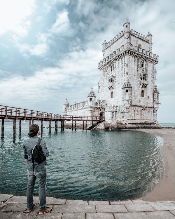 Free Person Standing in Front of Belem Tower Stock Photo