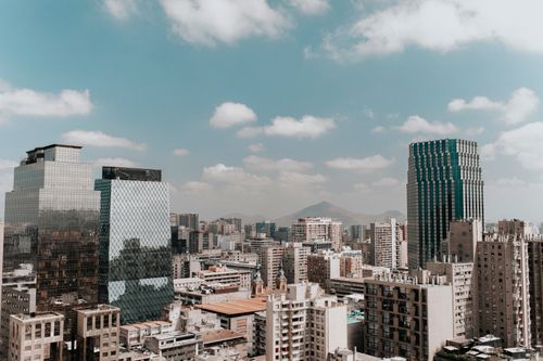 Free View of Santiago's skyline featuring modern architecture and surrounding mountains under a clear sky. Stock Photo