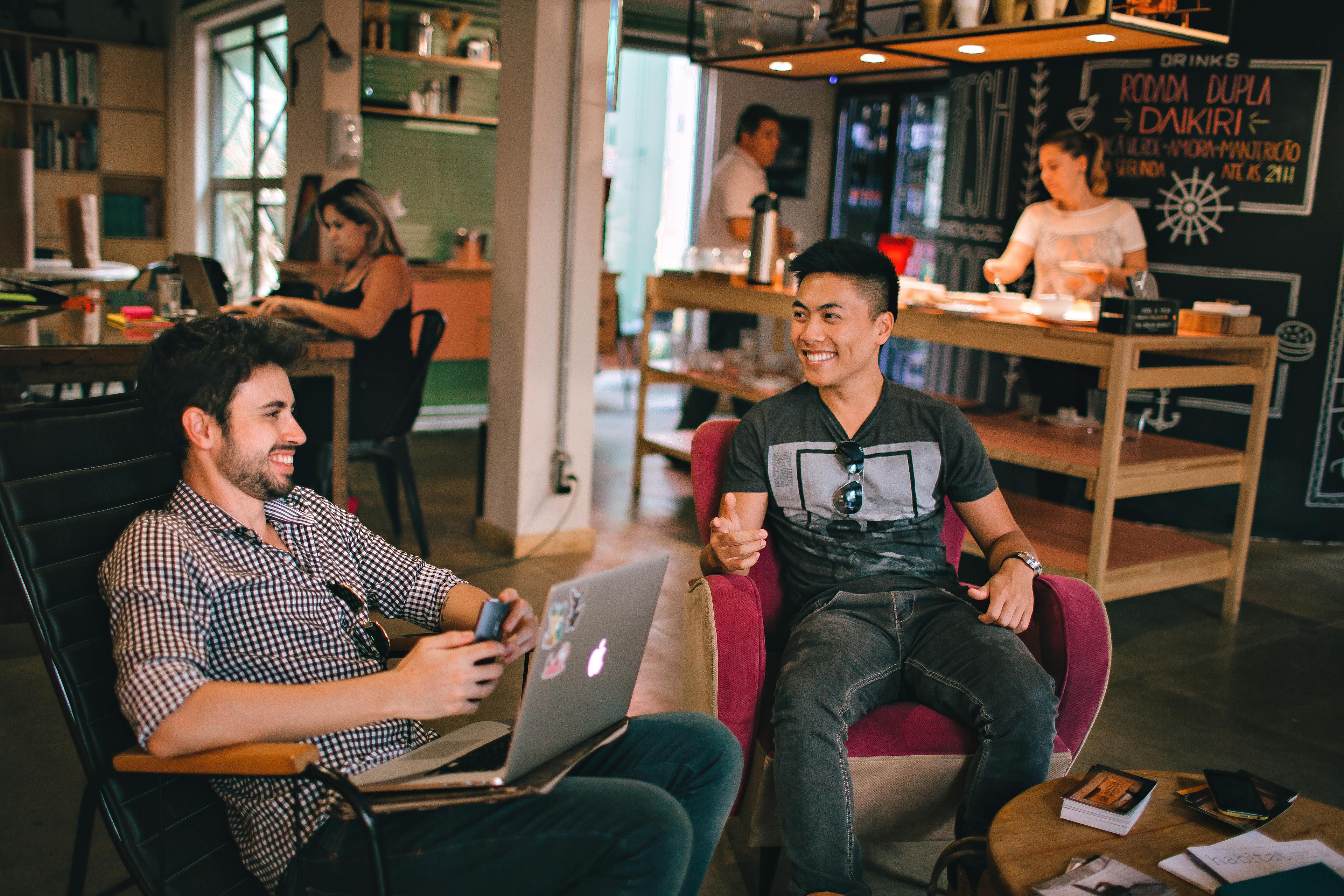 Photograph of Men Having Conversation Seating on Chair