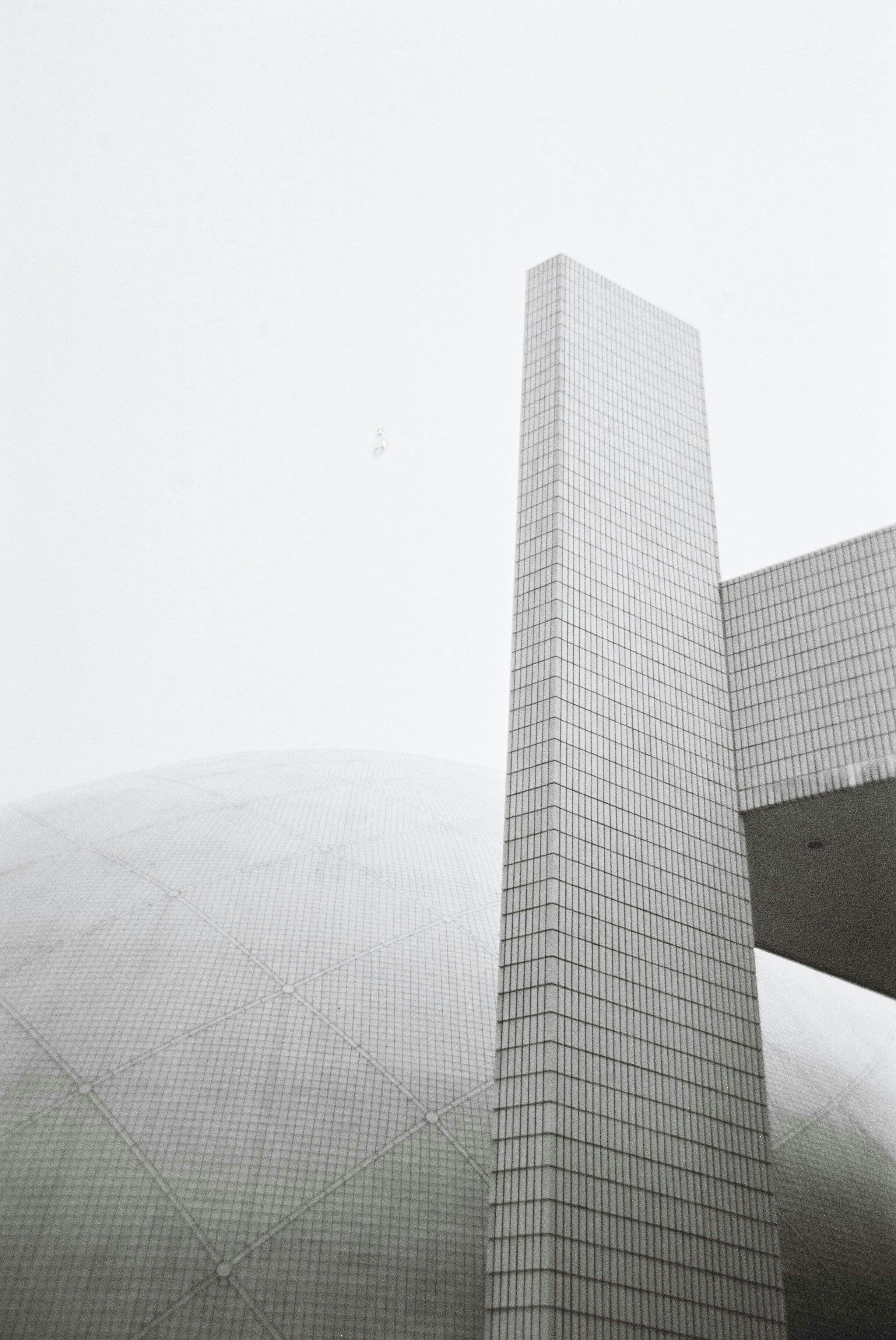 Minimalist view of modern architecture in Hong Kong, showcasing clean lines and urban design.
