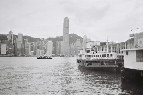 Grayscale Photo of Ferry on Body of Water