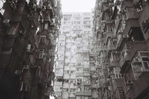 Concrete Building with Glass Windows in Grayscale Photography