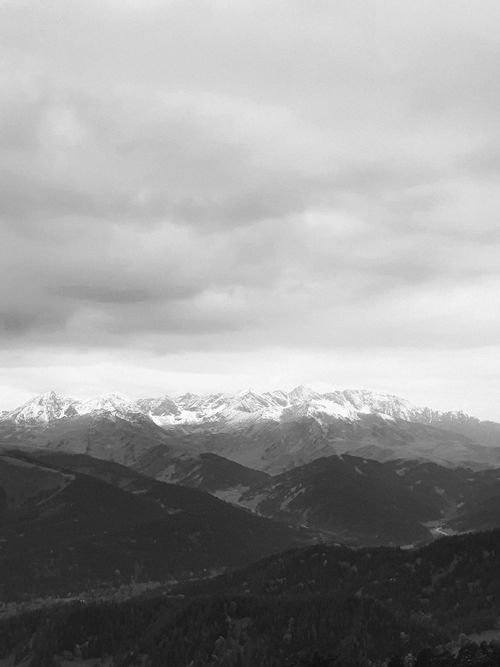 Free Aerial view of snow-capped mountains in Arkhyz, Russia, under dramatic skies. Stock Photo