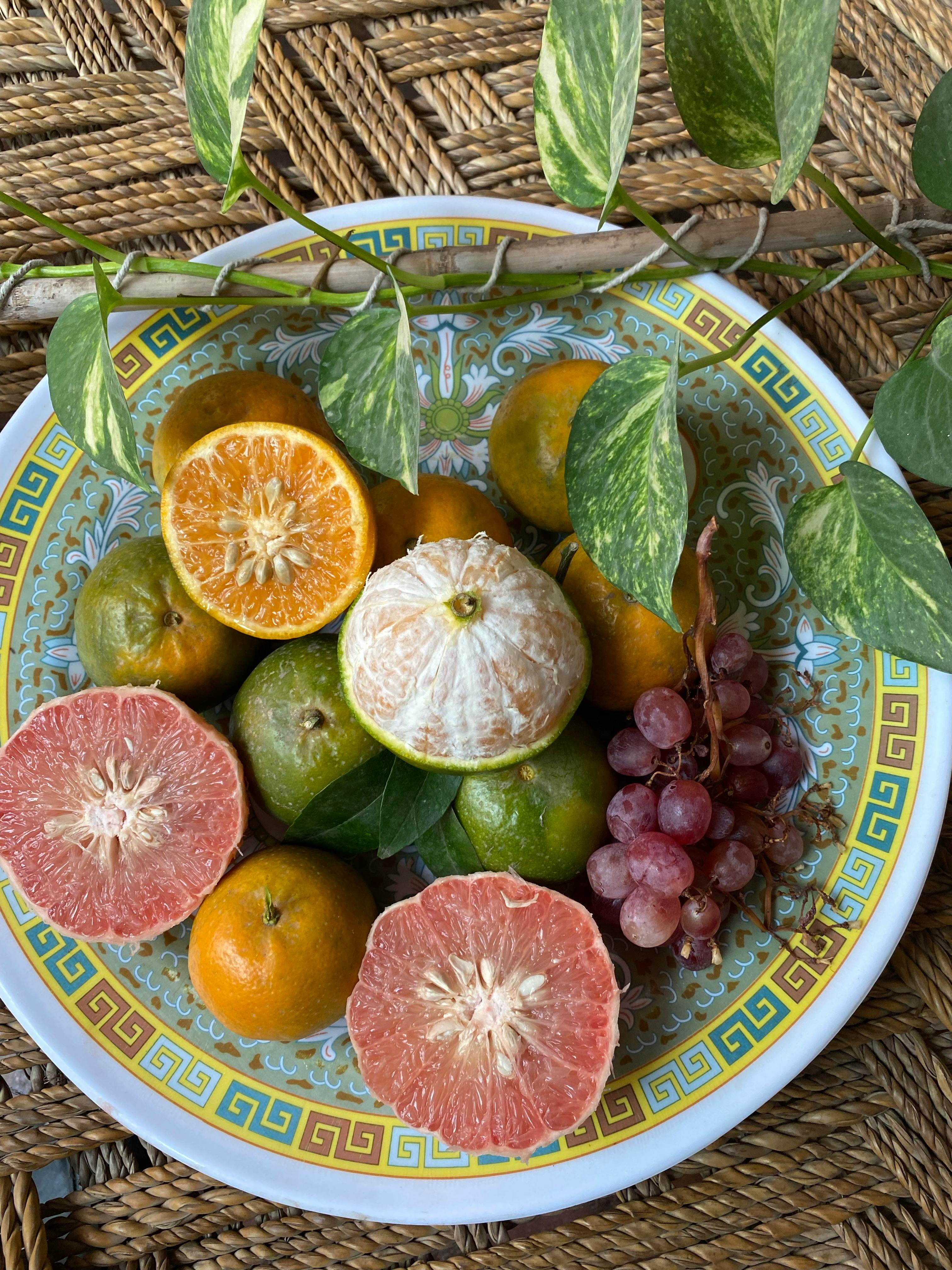 Citrus Fruits and a Cluster of Grapes on a Plate · Free Stock Photo