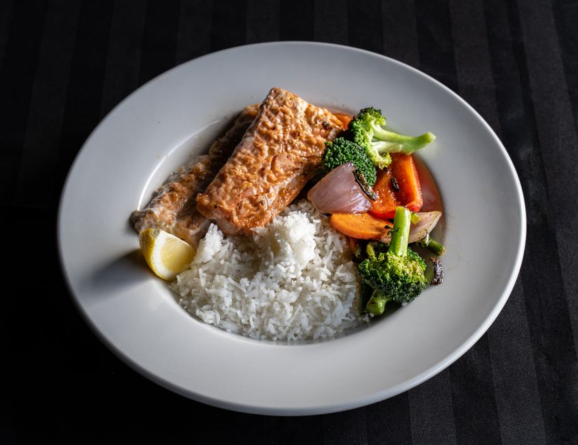 A balanced Mediterranean-style plate with salmon, greens, and quinoa A balanced Mediterranean-style plate with salmon, greens, and quinoa