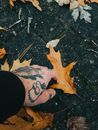 Person With Black Tattoo on Right Leg