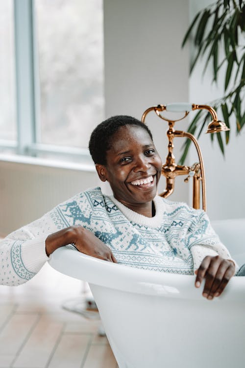 Woman Smiling in a Bathtub