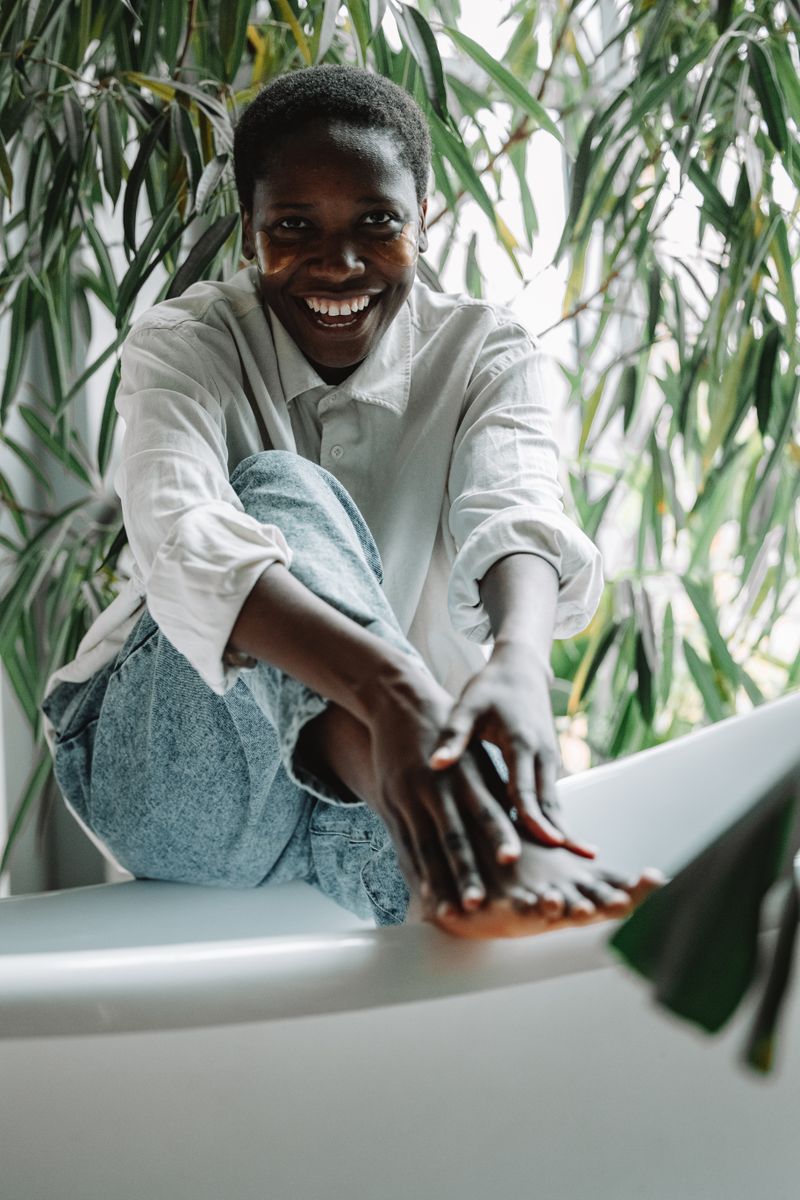 Woman smiling among vibrant green plants
